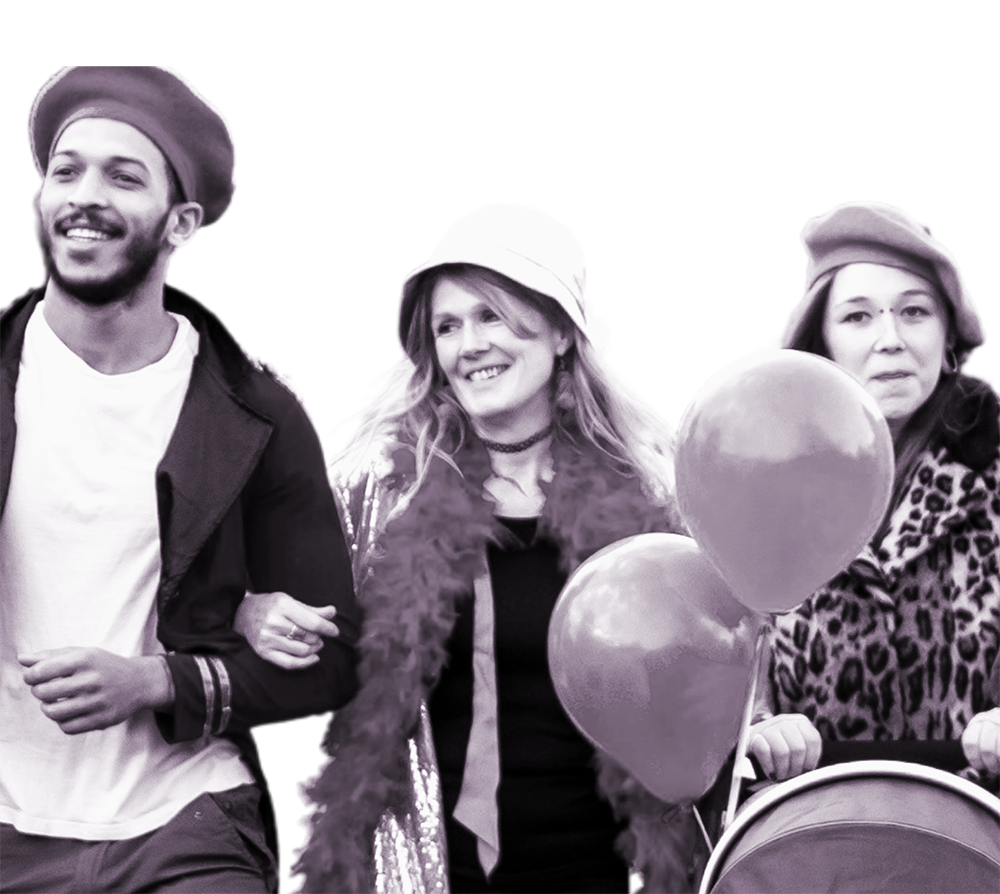 Three people with baloons, smiling.